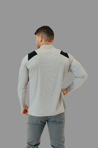 Back view of the Ghost Grey long sleeve golf shirt with black panels across the shoulders