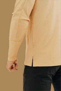 Close-up of the split side hem and ribbed knit on the King's Gold long sleeve golf shirt