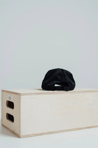 Back of the Midnight Black Give Your All golf hat showing the adjustable strap