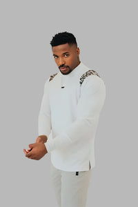 Man in the White/Camo long sleeve golf shirt, hands clasped, grey backdrop