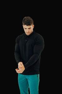 Man adjusting the cuff of the All Black long sleeve golf shirt