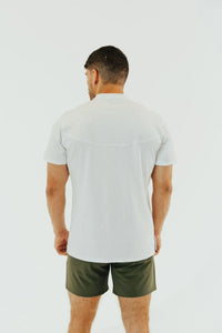 Rear view of the Blizzard White short sleeve golf shirt and dark olive shorts