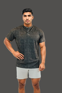 Volcanic Ash men's golf shirt, hand on hip, dark heathered striped fabric
