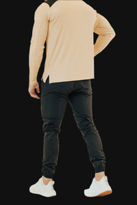 Back view of Midnight Black golf joggers with cuffed ankles, tan long sleeve top