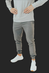 Storm Grey golf joggers front view, hands on hips, light grey long sleeve top