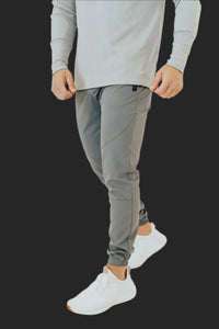 Storm Grey men's golf joggers with cuffed ankles and white sneakers