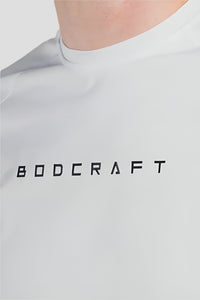 Close-up of the BODCRAFT wordmark print near the collar of the Blizzard White shirt