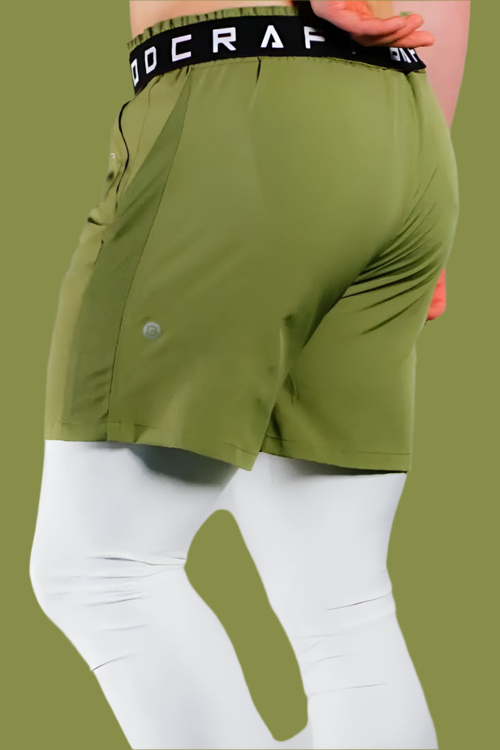 Back view of Army Green training shorts worn over white base-layer leggings