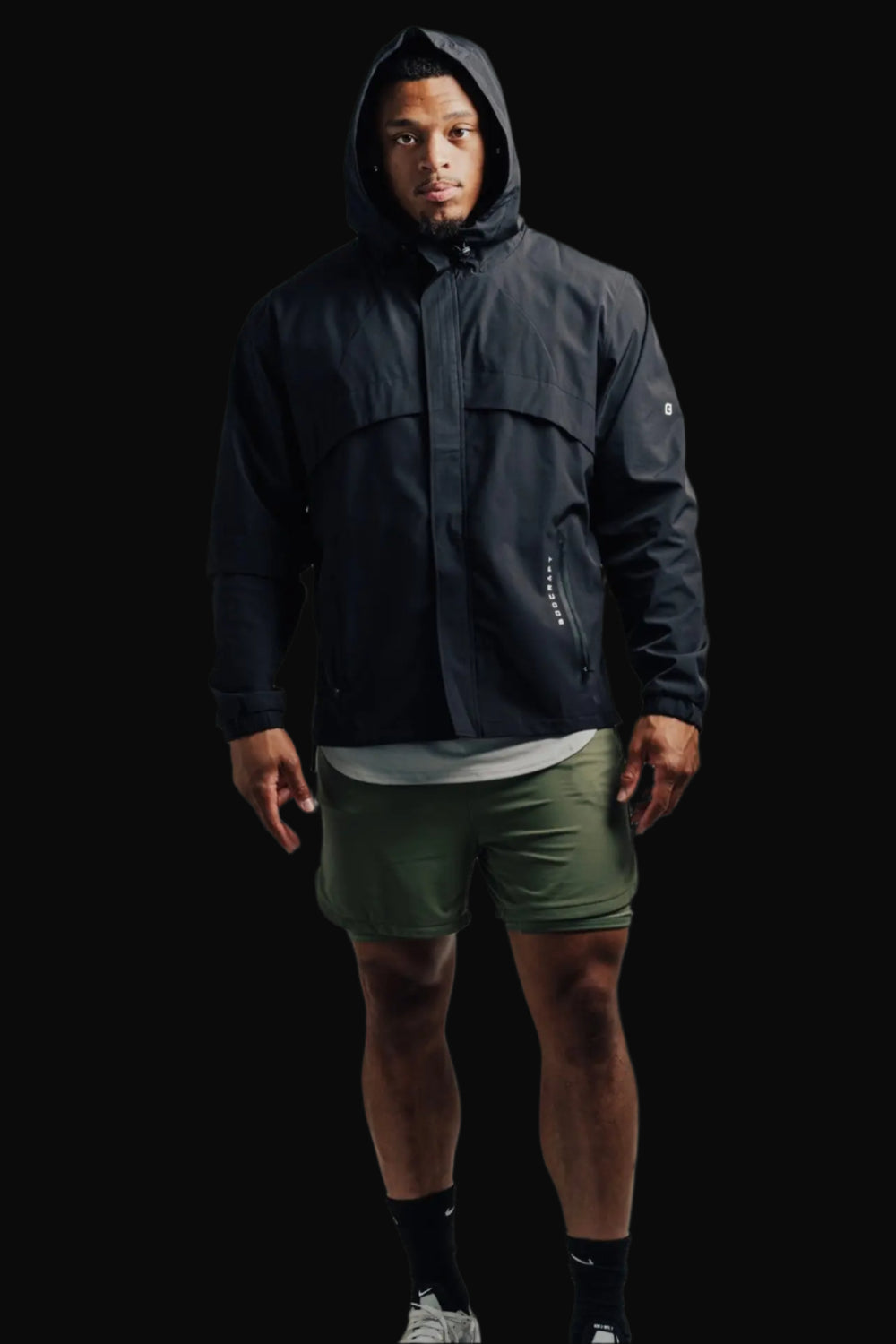 Man in a Midnight Black Ai1 Stealth jacket with the hood up