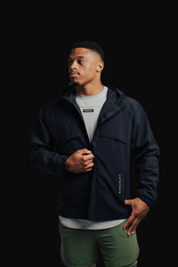 Unzipping the Midnight Black Ai1 Stealth jacket over a grey tee
