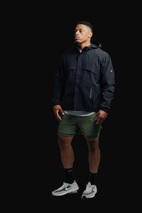 Man in a Midnight Black Stealth jacket and olive shorts, full length