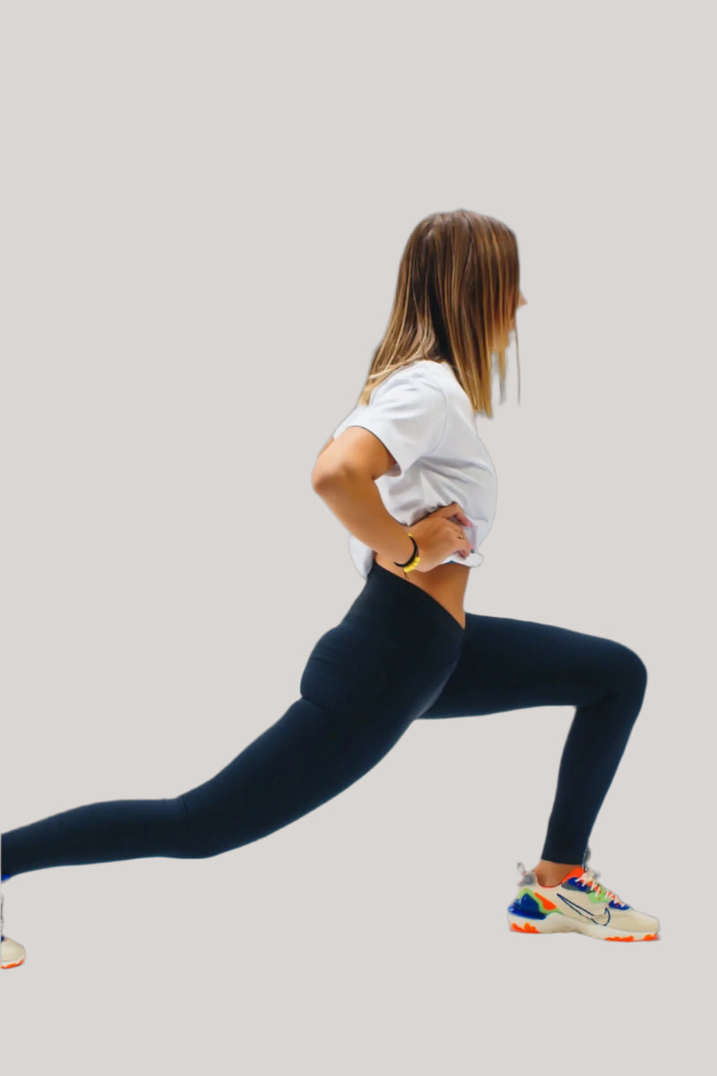 Woman lunging in a Blizzard White Energy cropped tee and navy leggings