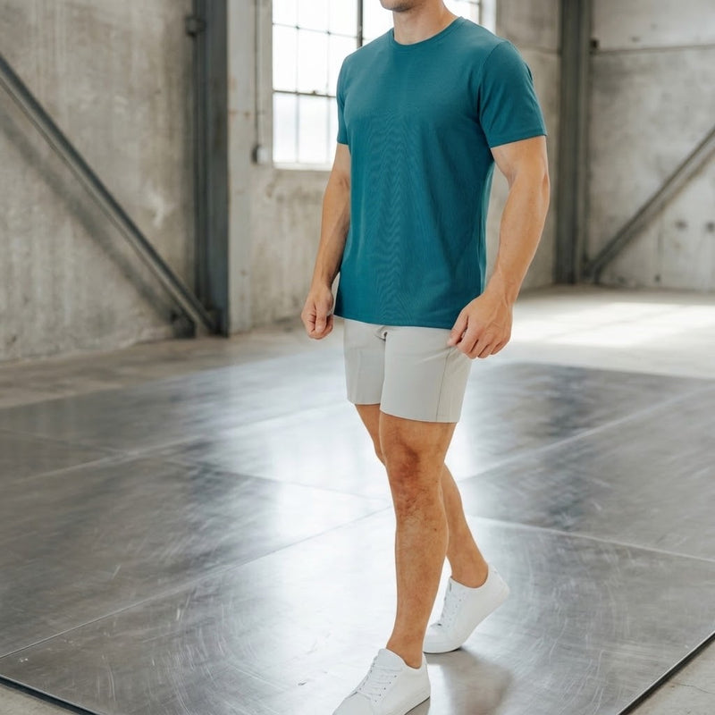 Ghost Grey 6 inch inseam golf shorts paired with a teal tee and white sneakers