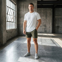 Dark Olive 6 inch golf shorts with a white crew-neck tee and grey sneakers, full-length front view