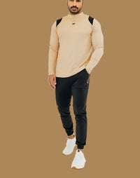 King's Gold long sleeve golf shirt with black shoulder panels, black joggers, white sneakers