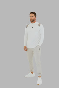 White long sleeve golf shirt with camo shoulder panels, worn with light grey joggers