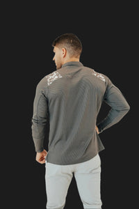 Back view of the Storm Grey/Camo long sleeve golf shirt showing camo across the shoulders