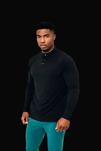 All Black men's long sleeve golf shirt, fitted through the chest, on a black backdrop