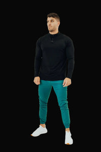 Full-length look: All Black long sleeve golf shirt with teal joggers and white sneakers