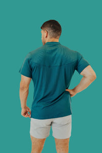 Pine Green golf shirt from behind showing the yoke seam across the shoulders