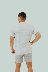 Rear view of the off-white Snowstorm golf shirt showing the split hem