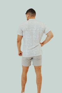 Snowstorm short sleeve golf shirt from behind, hand on hip