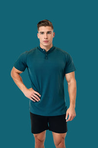 Front view of the Titan Blue men's golf shirt with stand collar, hand on hip