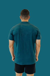 Back view of the Titan Blue short sleeve golf shirt and black shorts
