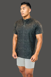 Man in the Volcanic Ash golf shirt with light grey shorts, front view