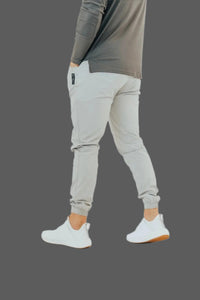 Ghost Grey golf joggers walking shot, hand in pocket, white sneakers