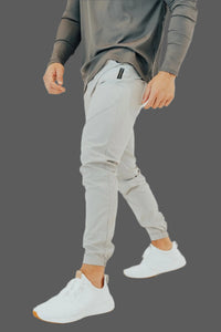 Man mid-stride in Ghost Grey golf joggers with a charcoal long sleeve top