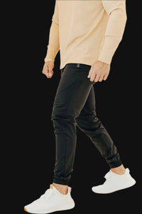 Man walking in Midnight Black golf joggers and white sneakers, tapered leg