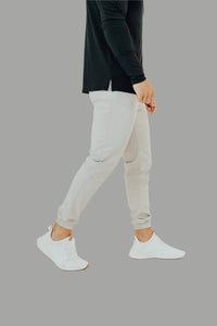 Pebble Grey golf joggers mid-stride with a black long sleeve top