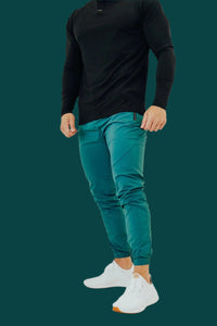 Pine Green golf joggers in a teal shade with a black long sleeve shirt
