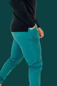 Side close-up of Pine Green golf joggers, hand in the pocket