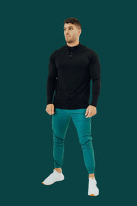 Pine Green men's golf joggers with white sneakers, front view