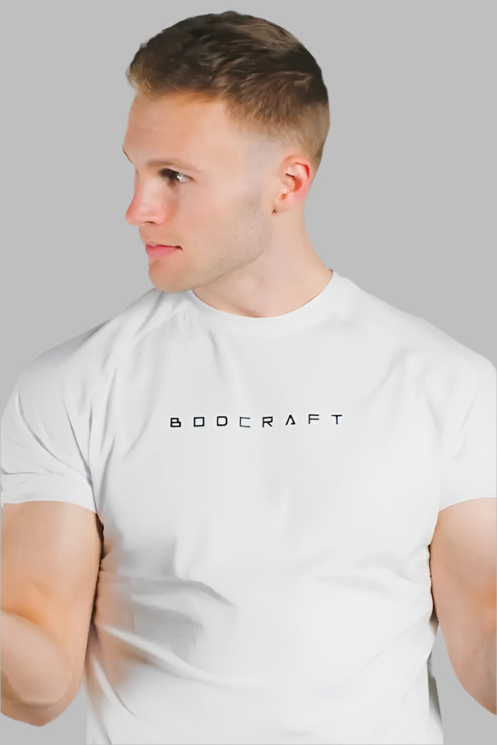 Man wearing a Blizzard White short sleeve training shirt, profile view with face