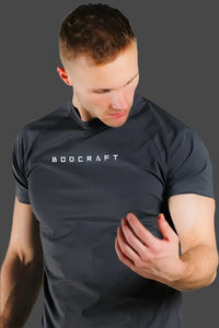 Man in a Shadow Grey short sleeve shirt looking down, sleeve and arm detail