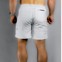 Back view of a shirtless model in white BodCraft training shorts