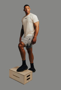 Foot up on a plyo box in Ghost Grey Ai1 lined training shorts
