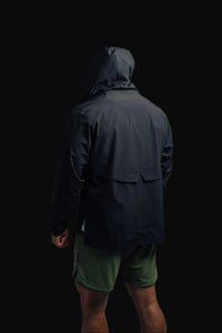 Back view of the black Stealth jacket with hood up and green shorts