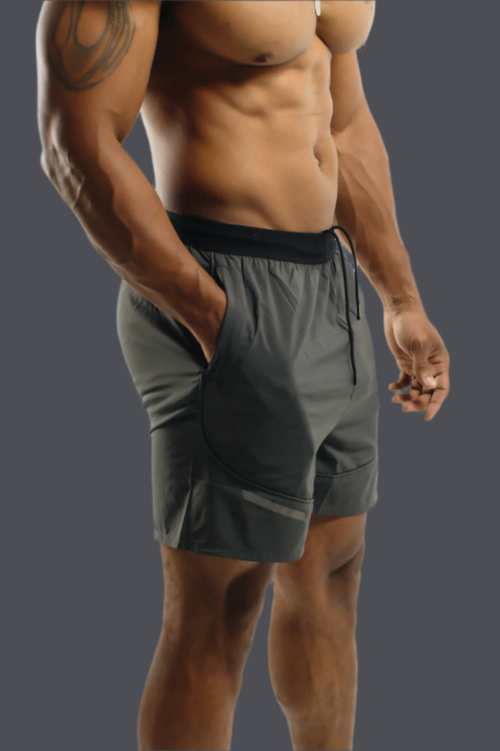 Storm Grey Battle training shorts, hand in the side pocket, three-quarter view