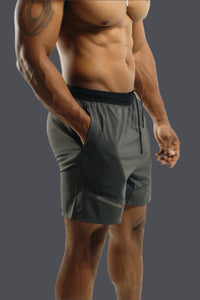 Storm Grey Battle training shorts, hand in the side pocket, three-quarter view