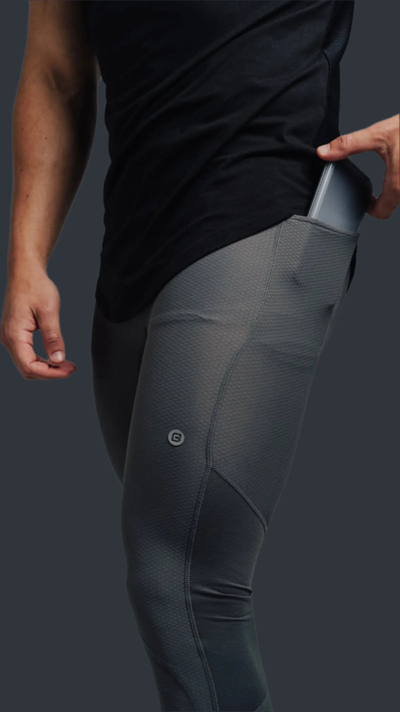 Phone sliding into the side pocket of Storm Grey training tights