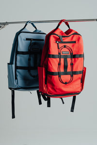 Kingdom Red and Carolina Blue Ai1 backpacks hanging together, front view