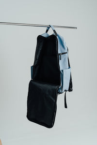 Carolina Blue Ai1 backpack hanging with the front panel folded open to show the lining