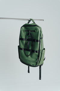Army Green Ai1 gym backpack hanging on a rail, front view with side pockets
