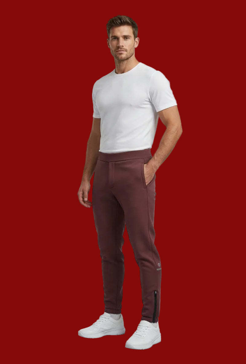 Man wearing a white t-shirt and brown pants on a plain background