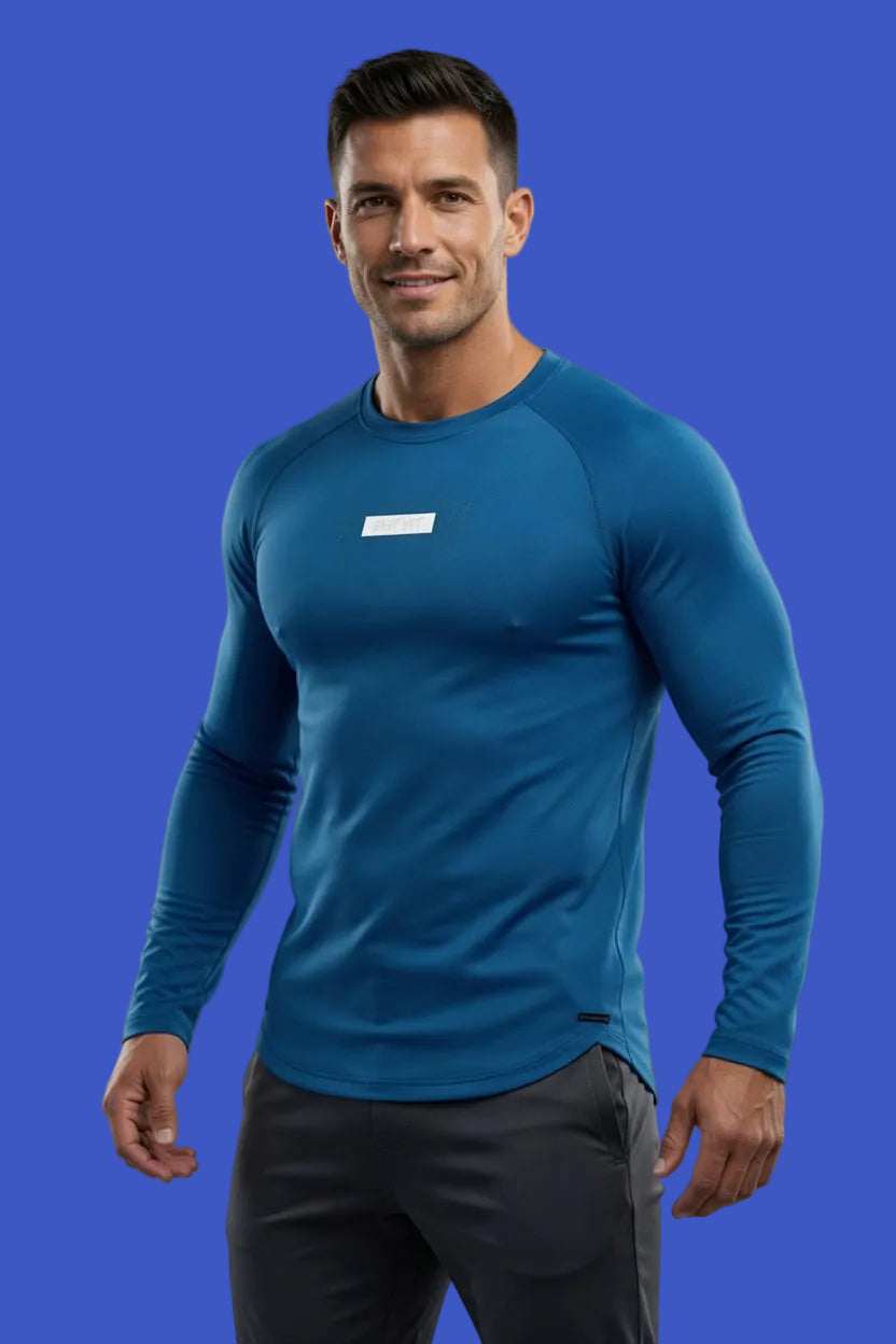 Man wearing a blue athletic long-sleeve shirt with a logo on a gray background