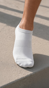 Close-up of a Blizzard White low-cut training sock on a concrete step